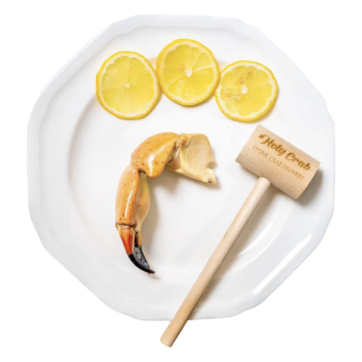 Jumbo Stone Crab Claws on plate with wood mallet & lemons | Jumbo Stone Crab Claws Home Delivery | Now Available: Jumbo Stone Crab Claws Shipped Overnight to Your Plate | Product Photo